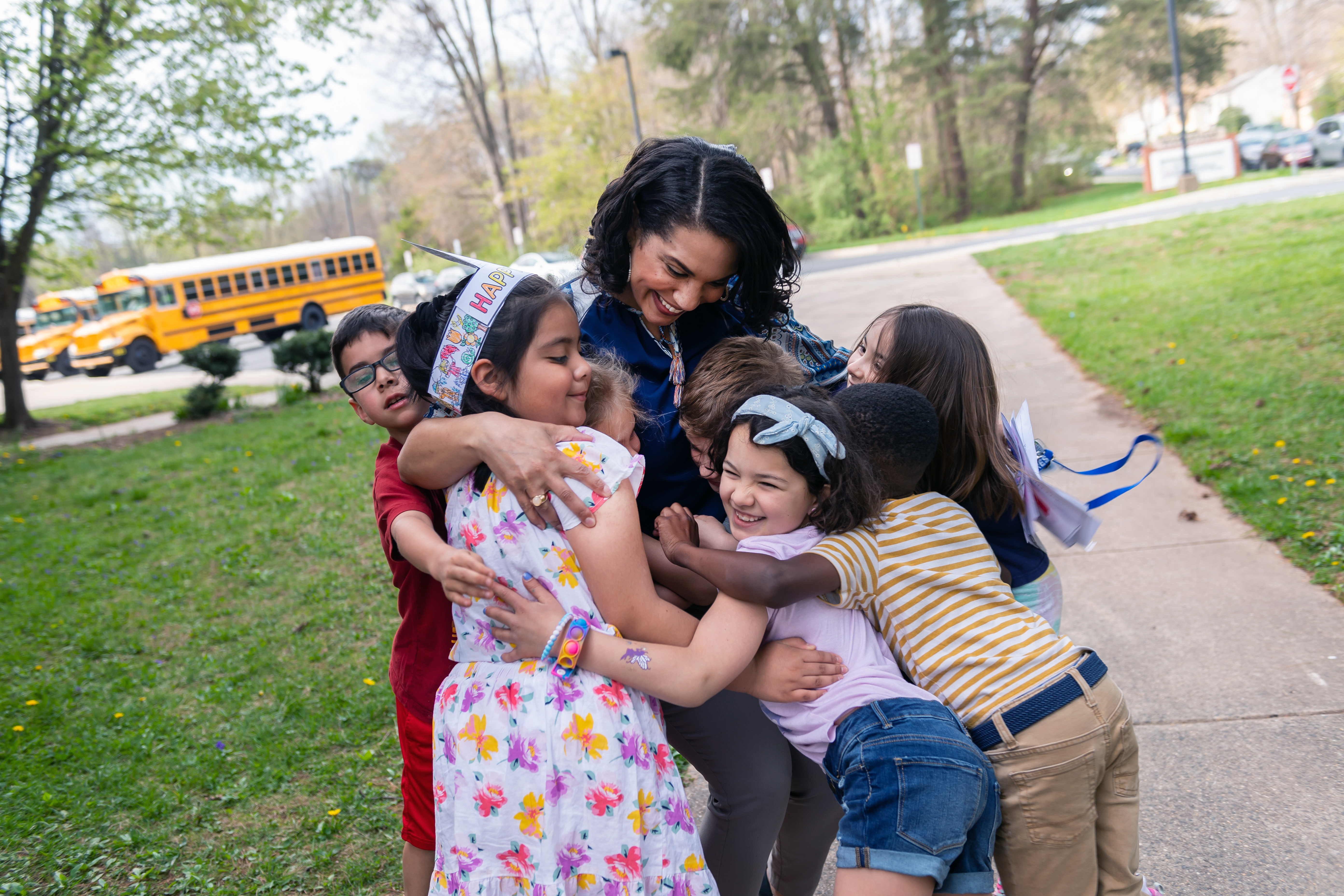 A principal hugs students