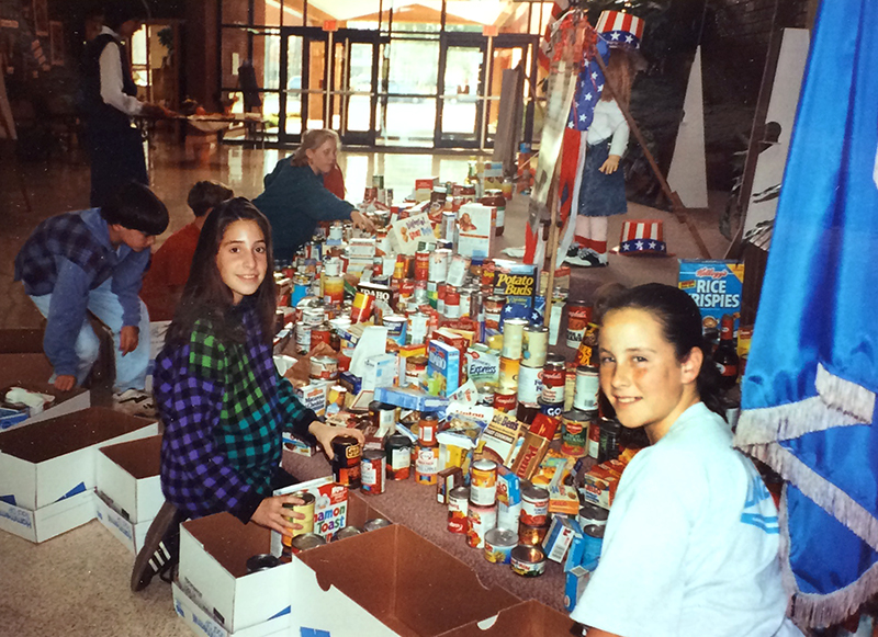 Photograph of students organizing donated food from the 1994 food drive.
